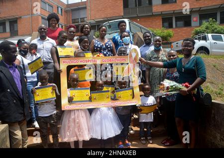 Kampala, Uganda. 15th Feb, 2022. Childhood cancer survivors and their parents pose for a group photo during an activity to mark International Childhood Cancer Day at Mulago National Referral Hospital in Kampala, Uganda, on Feb. 15, 2022. As the world commemorates International Childhood Cancer Day on Tuesday, free treatment of children with cancer in Uganda is reigniting their hope. Credit: Nicholas Kajoba/Xinhua/Alamy Live News Stock Photo