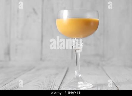 Glass of Eggs-cellent Cocktail on wooden background Stock Photo
