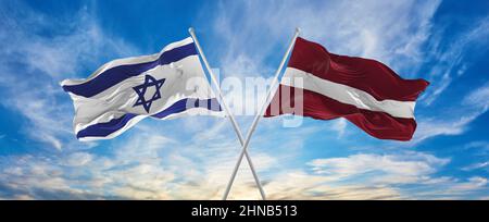 two crossed national flags of Israel waving in the wind at cloudy sky ...