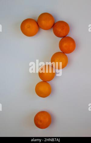 question mark made from whole oranges on white background , top view Stock Photo