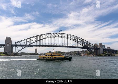 The Emerald-class ferry Fairlight passing in front of the Sydney Harbour Bridge on a summer's day Stock Photo