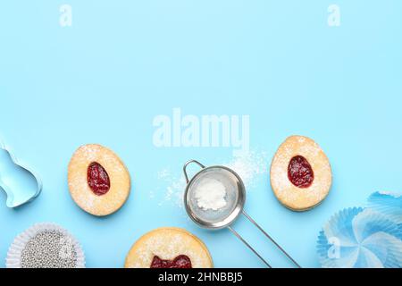 Delicious Easter cookies and utensils on blue background Stock Photo