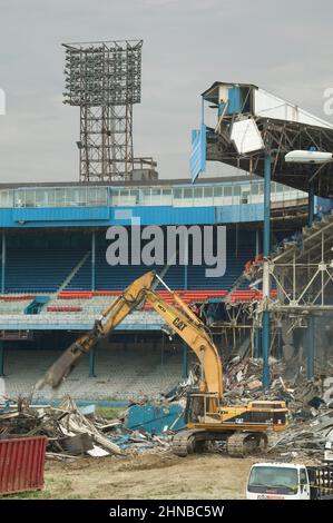 A yellow excavator demolishing Detroit Tiger Stadium Stock Photo