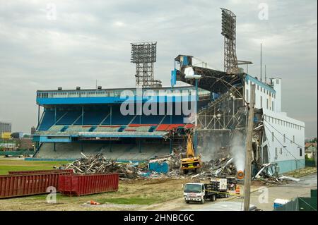 A wide view of a yellow excavator demolishing Detroit Tiger Stadium Stock Photo