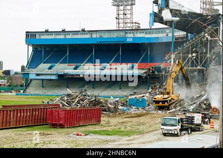 A yellow excavator demolishing Detroit Tiger Stadium Stock Photo