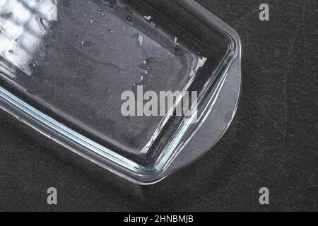 A baking dish cleaned from a thick layer of carbon. Glassware for baking after washing with a steam cleaner. Stock Photo