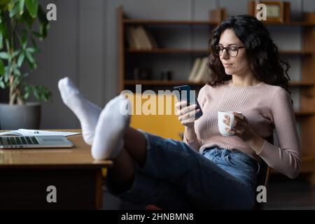 Female remote worker suffer from luck of concentration surfing social media avoid work on computer Stock Photo
