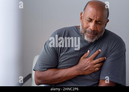 Portrait of an older senior man having chest pain. Stock Photo