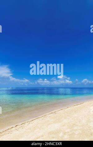 White sand beach and turquoise blue sea under a blue sky Stock Photo ...