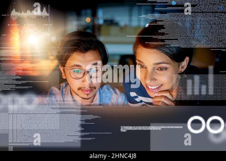 We cracking the code. Shot of computer programmers looking through data in the office. Stock Photo