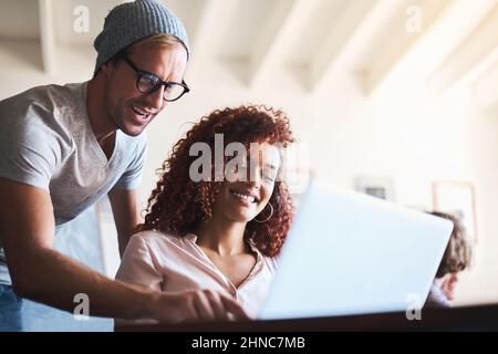 Lets see what our clients think about our new product. Cropped shot of two designers discussing something on a laptop. Stock Photo
