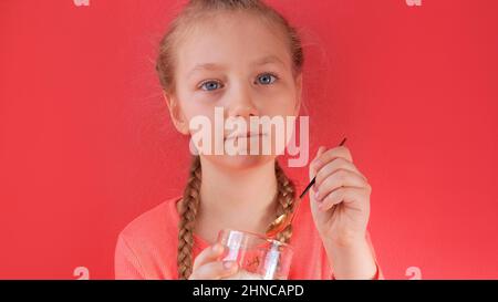 Child eating yogurt jelly pink background. Dairy product diet Lactobacillus Acidophilus, healthy homemade breakfast menu. Kids healthcare. Vegan food Stock Photo