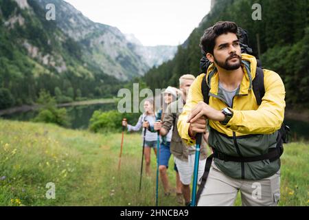 Group of fit healthy friends trekking in the mountains Stock Photo