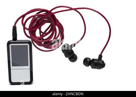 Close up of silver black music player with red cable headphones on it on white background concept for enjoyment and mobile music listening Stock Photo