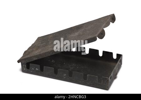 Close up of very old rusty vintage textured small metal box with slightly opened lid on white background Stock Photo