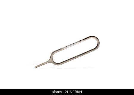 Close up of metal cell phone sim needle tool for ejecting and removing telephone card from smart phones on white background Stock Photo