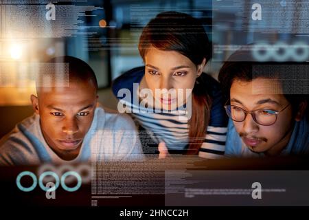 Trying to fix software issues together. Shot of computer programmers looking through data in the office. Stock Photo