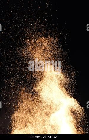 Sparks from a bonfire flying in the night Stock Photo