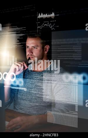 Programming requires razor-sharp focus. Shot of a focussed computer programmer working at his computer late at night. Stock Photo