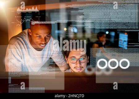 Getting this done before we reach the deadline. Shot of computer programmers looking through data in the office. Stock Photo