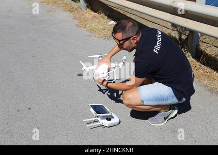 Drone pilot preparing the drone on the street Stock Photo