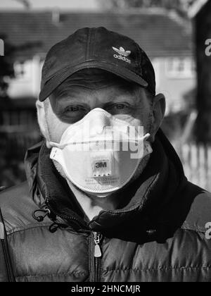 Grayscale shot of a caucasian man wearing a mask in Wolverhampton, England Stock Photo