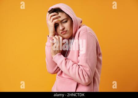 Young short-haired woman with weird expression iin studio Stock Photo