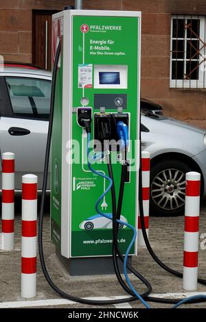 24 January 2022, Kaiserslautern, Germany, Green Pfalzwerke charging station for electric cars with different plugins, green mobility (vertical)