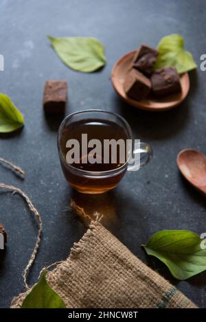 Energy drink black tea served in a cup. Close up. Stock Photo