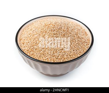 White quinoa seeds in a brown bowl are isolated on a white background in the bowl. Side view. Stock Photo