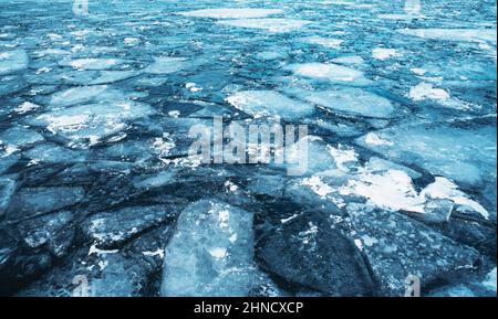 Blue uneven ice on the lake, abstract natural background. Stock Photo