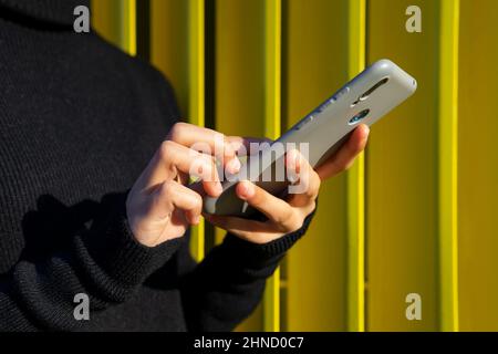 Islamic male in authentic white clothes while standing against grungy wall Stock Photo
