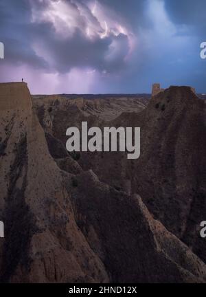Breathtaking scenery of rocky formations in highlands under thunderstorm sky with clouds and lightnings Stock Photo