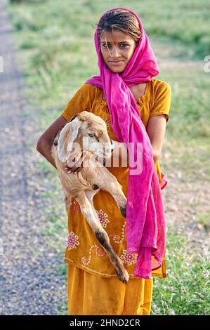 India Rajasthan. Portrait of a beautiful girl withe her goat in Khimsar Stock Photo