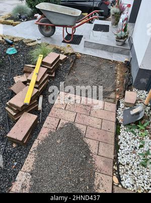 Worker laying pavement rocks Stock Photo