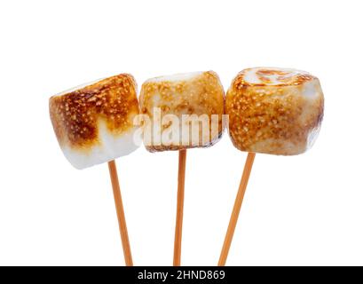 Grilled marshmallows on sticks isolated on white Stock Photo