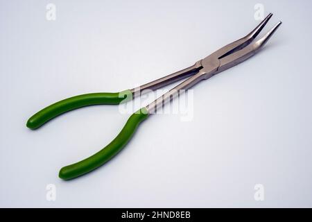 long-nosed platypuses with curved tips on a white background. Artisan's hand tool close-up. easy to work in the workshop Stock Photo