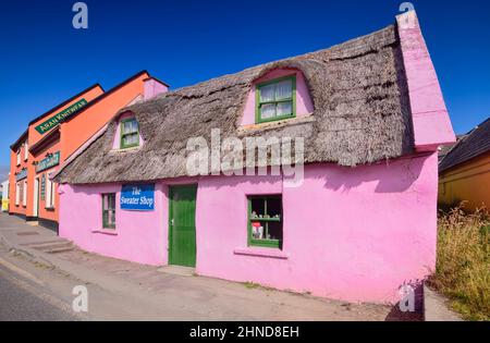 Ireland, County Clare, Doolin, Colourful craft shop known as The Sweater Shop with bright pink wall in the village. Stock Photo