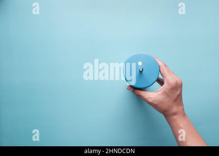 holding reusable eco coffee cup on blue  Stock Photo