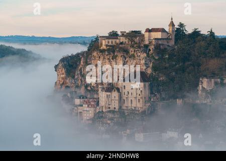 Rocamadour sunrise, Aerial view of the french village and castle on cliff in early morning with fogs in the Canyon of the Alzou Stock Photo
