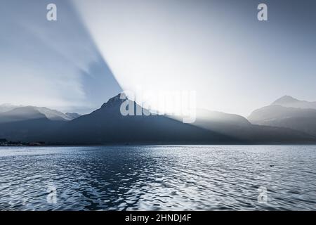 Fantastic landscape. Lights and shadows in the mountains and on the water of the lake. Stock Photo