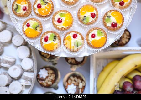 Fruit cupcakes decoration on a plate with cakes and fruits in the background Stock Photo