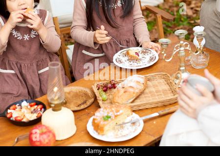 Japanese Sisters Eating Camping Rice Stock Photo