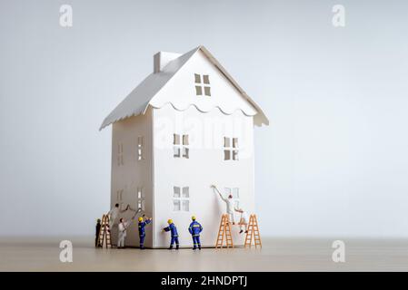 Figurines of builders and painters working on a house Stock Photo