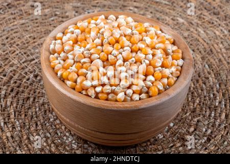 Dry corn seeds full of wooden bowl Stock Photo