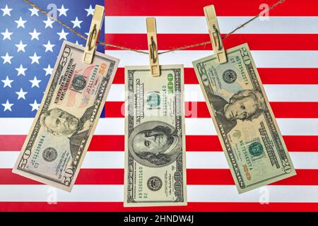 US dollar banknotes hanging on rope for money laundering concept. USA national flag background photo Stock Photo