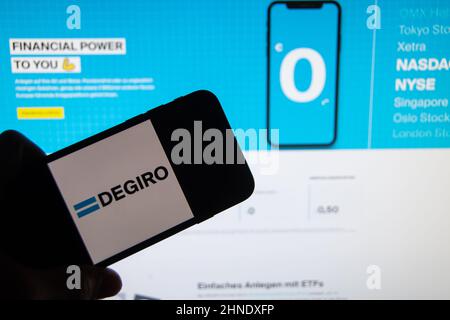 Rheinbach, Germany  15 February 2022,   The brand logo of the European broker company 'Degiro' on the display of a smartphone in front of the website Stock Photo
