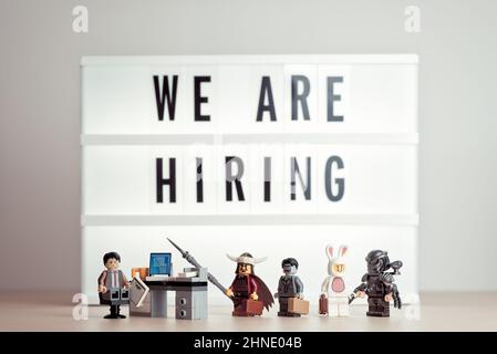 Diverse applicants in a queue waiting for interview. Illustrative editorial. January 14, 2022 Stock Photo