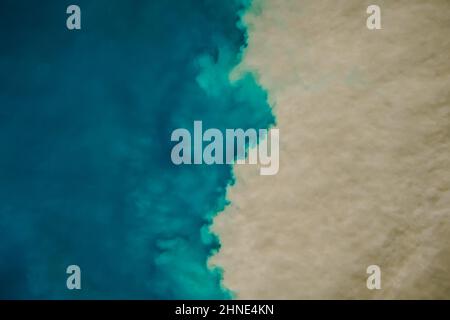 Aerial view of mixing blue and dirty ocean water. Natural abstract background Stock Photo