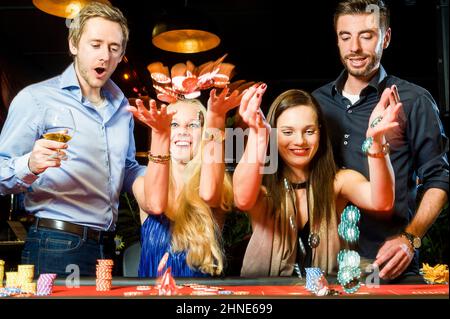 group of young people having fan with roulette in casino Stock Photo